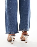Simmi London Wide Fit Bexley mid heeled mules with eyelet buckle detail in silver